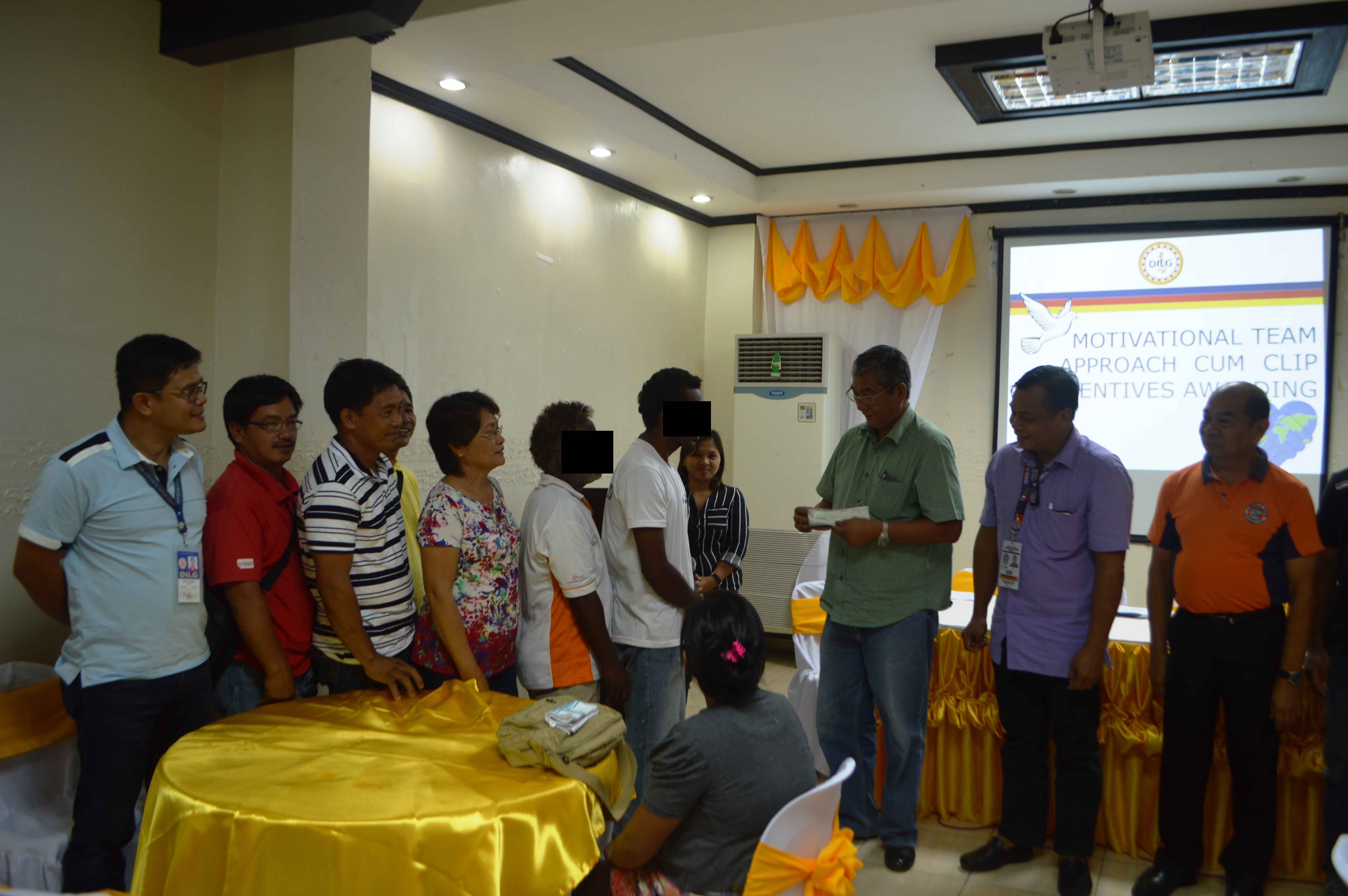 Beneficiary from Nagtipunan (M. Ramos) together with his father, Barangay Officials, MSWDO of Nagtipunan and MLGOO Erick C. Danao receiving the check from DILG RD John M. Castaneda, assisted by the PSWDO, PGO Representative, and JAPIC Team
